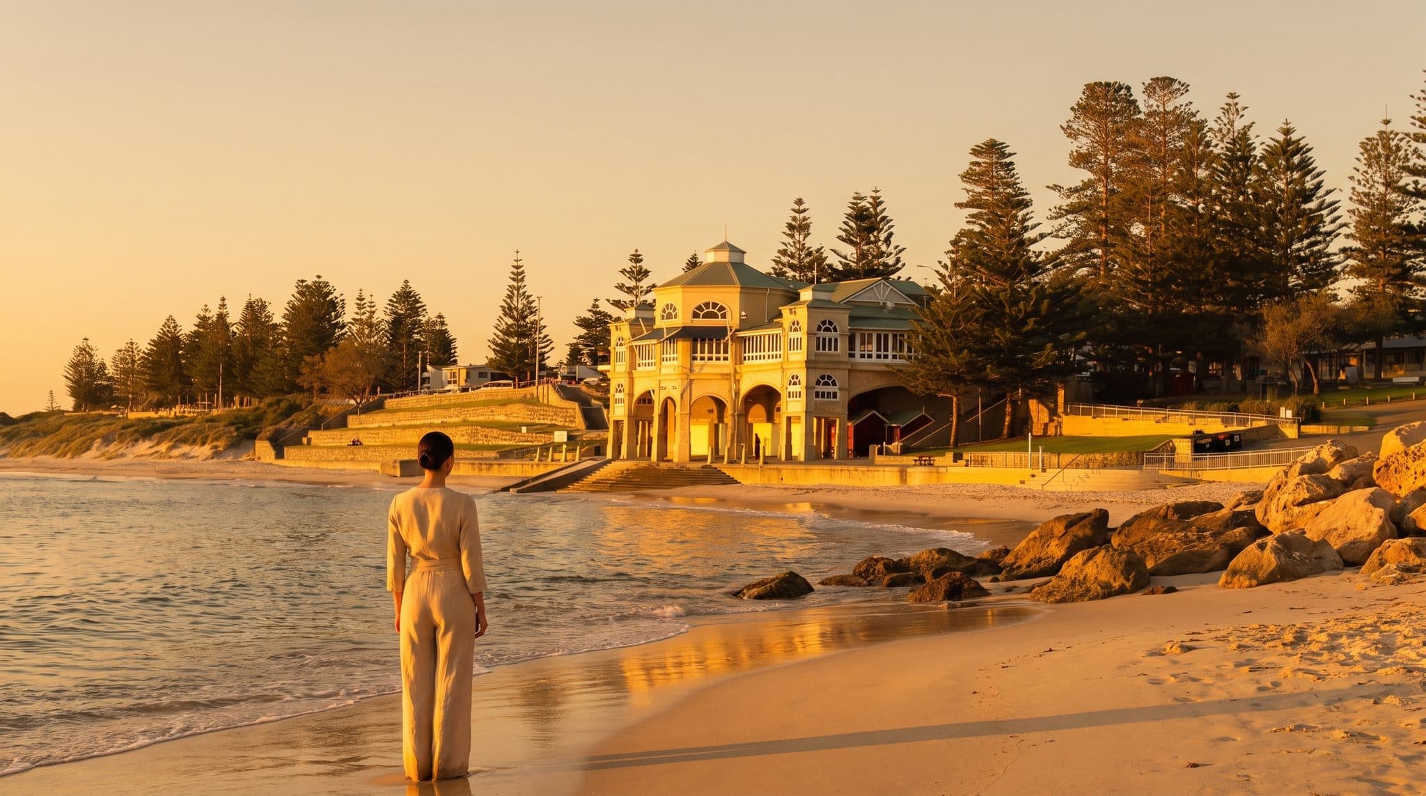 Cottesloe Beach at golden hour, a guest at the water's edge near the Indiana Tea House