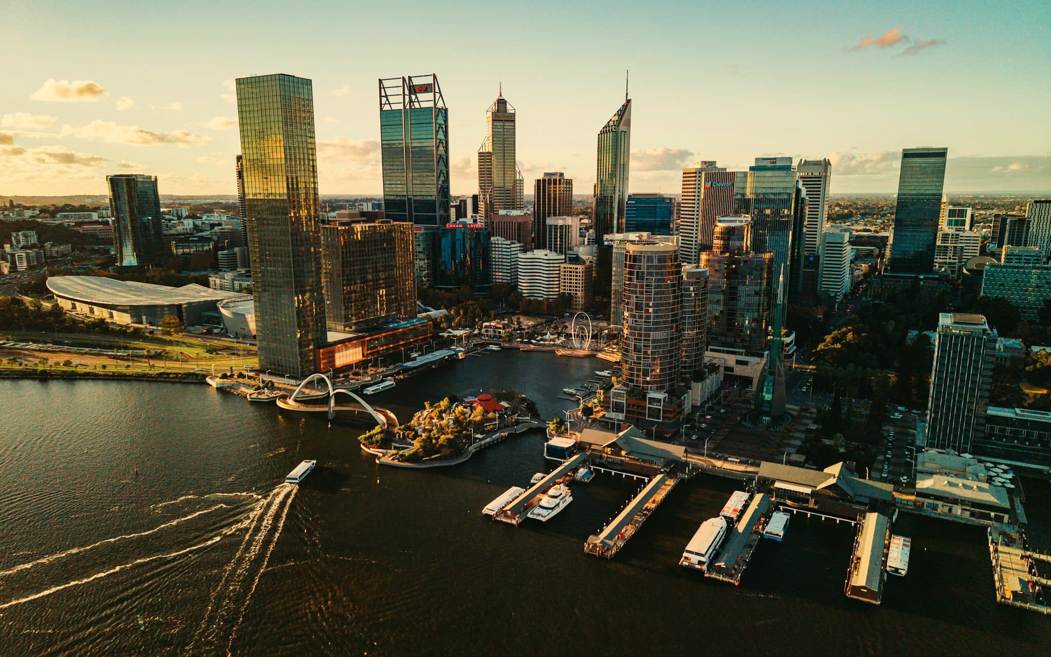 Elizabeth Quay from above in warm late light, ferries crossing the inlet